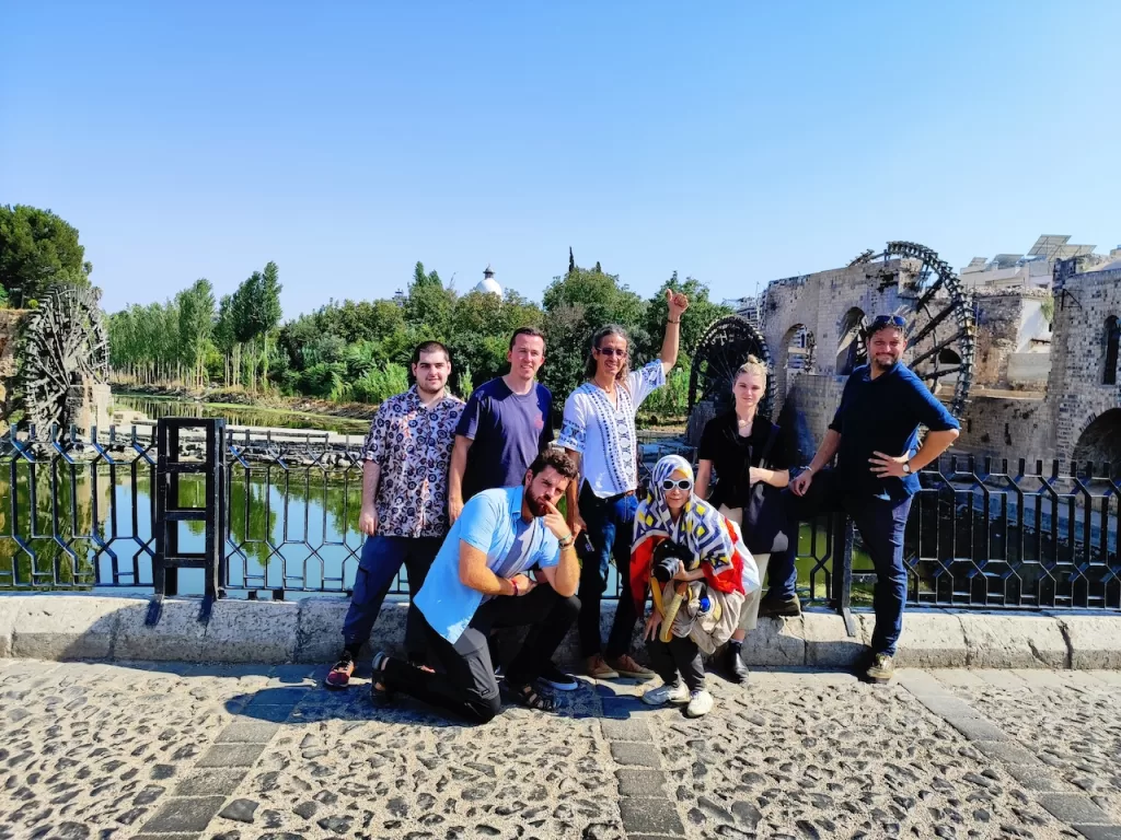 Tourists exploring Hama, Syria with its famous waterwheels.