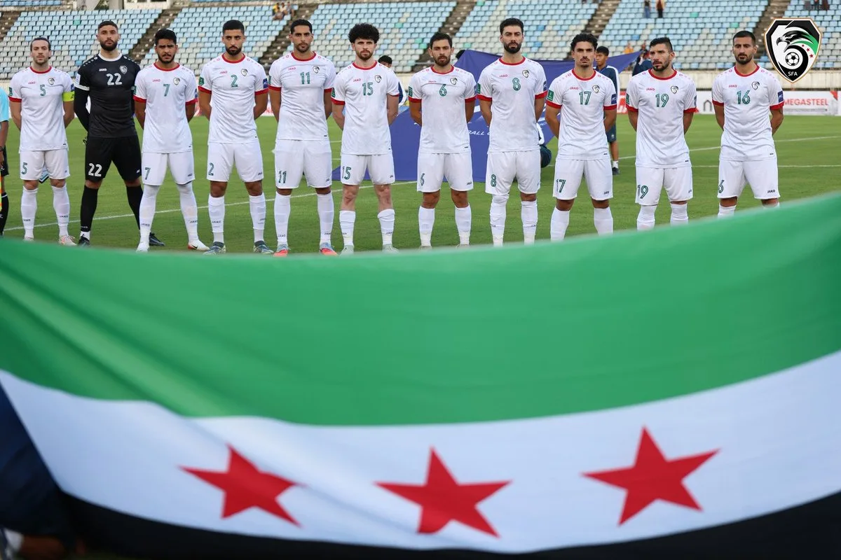 Syrian national football team playing in a rehabilitated stadium in Syria, showcasing resilience, culture, and unity after the war